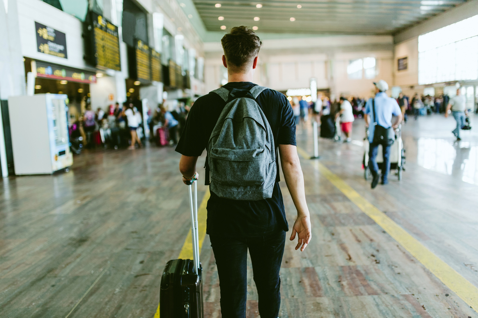 Young Man Walking in the Airport